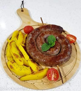 Boerewors recipe Served on a wooden serving plate with boerewors