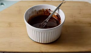 Stir in 2 tablespoons of hot water, one tablespoon at a time until the chocolate glaze is smooth and thick